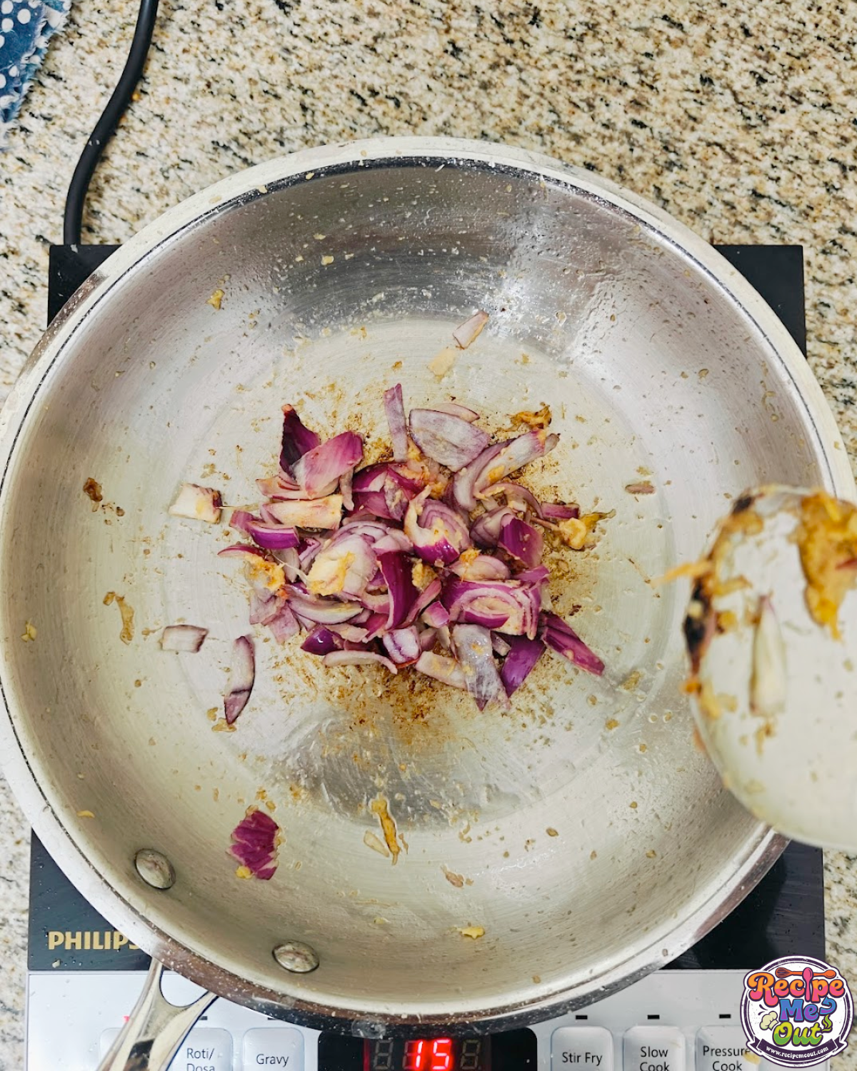 Chopped red onions added to the pan with garlic and being sautéed.