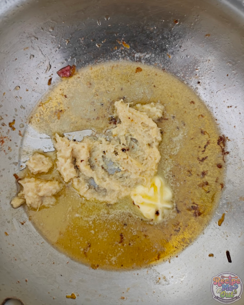Garlic added to melted butter in a pan and beginning to sauté.