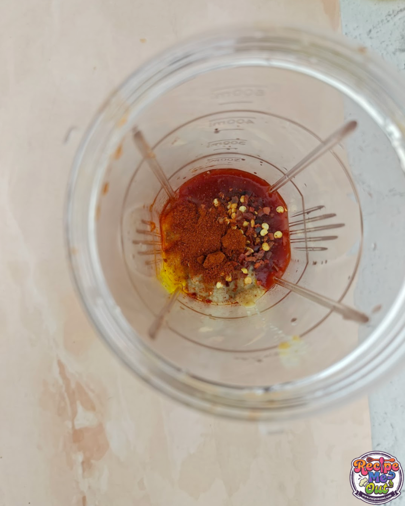 Smoked paprika powder and chilli flakes added to blender for tomato mustard pasta sauce