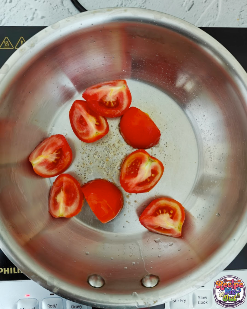 Fresh tomatoes sautéing in oil in a stainless steel pan for tomato mustard sauce pasta