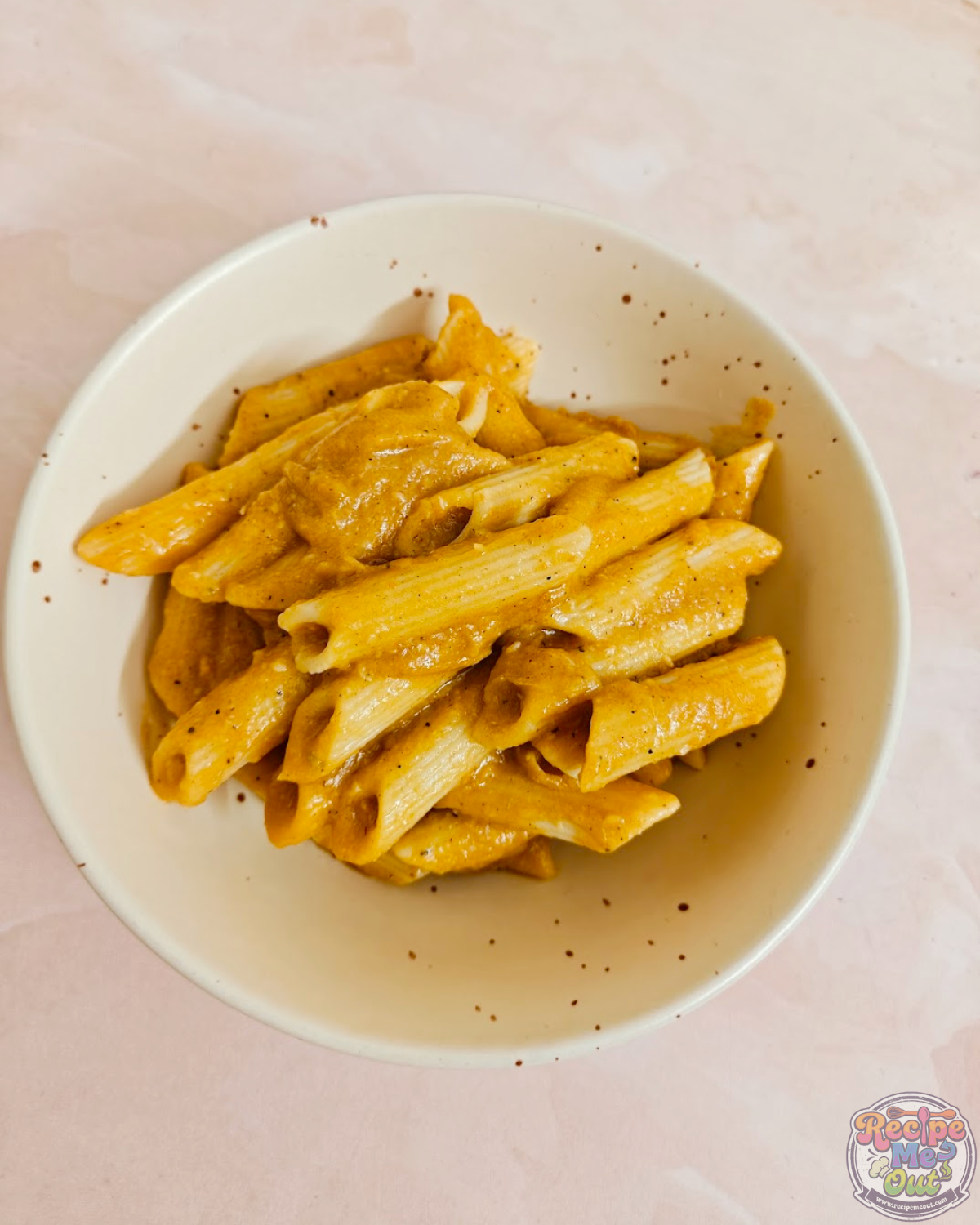 Top view of creamy pumpkin pasta served warm in a bowl.