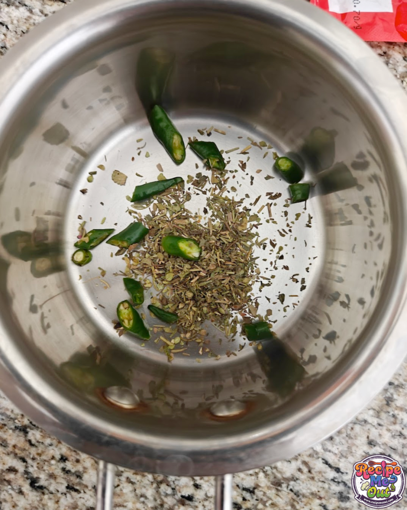 A small pan containing the herbs and chillies
