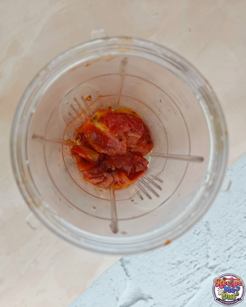 Cooked tomatoes transferred into a blender jar to prepare tomato mustard sauce