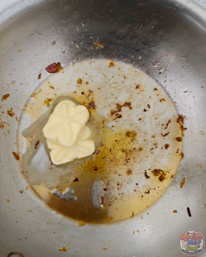 Butter melting in a pan to prepare the base for sautéing garlic.