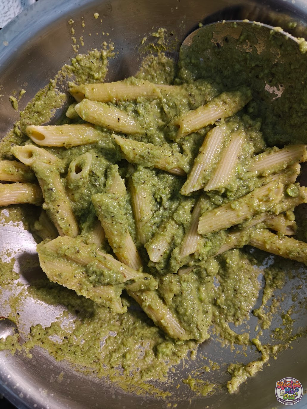 Pasta mixed with green peas sauce while preparing Green Peas Pasta