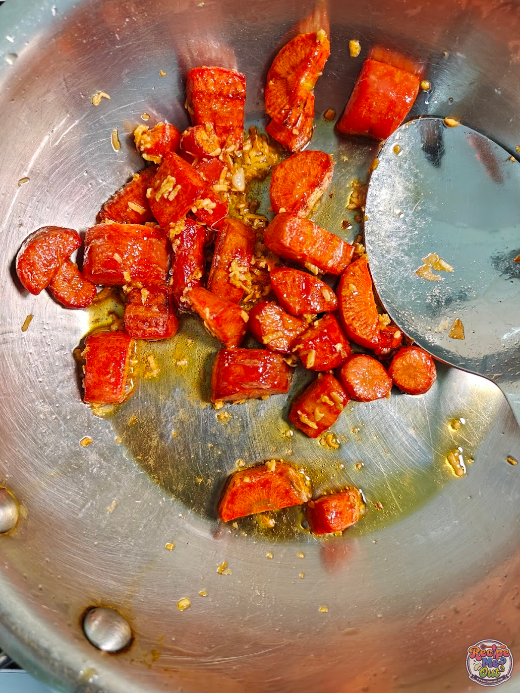 Grated ginger and garlic mixed properly with the sautéed carrots in a pan