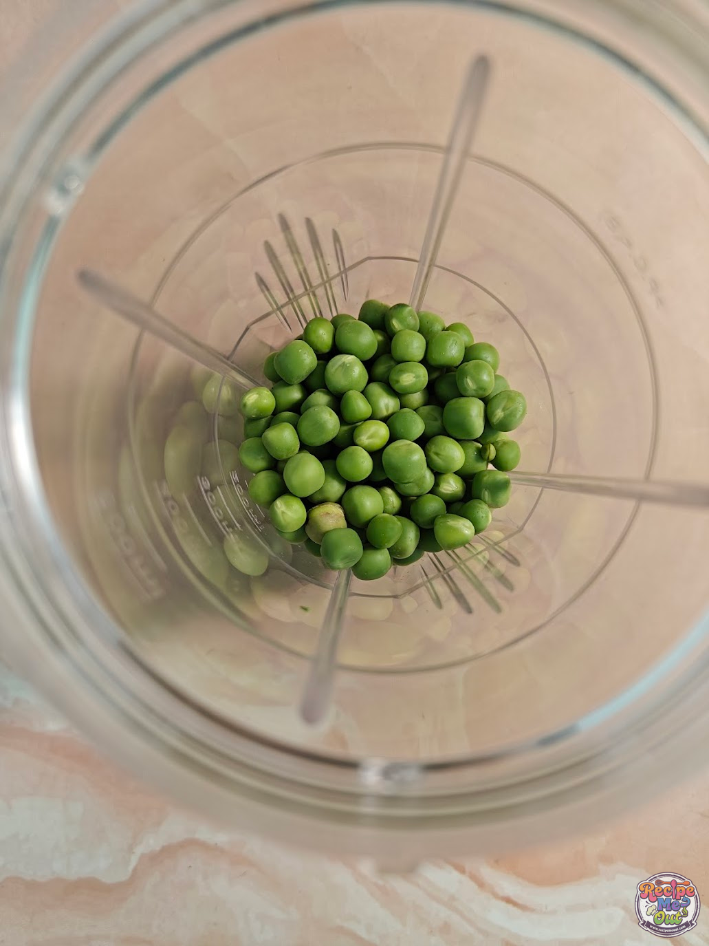 Fresh green peas added to a blender jar to prepare the Green Peas Pasta sauce
