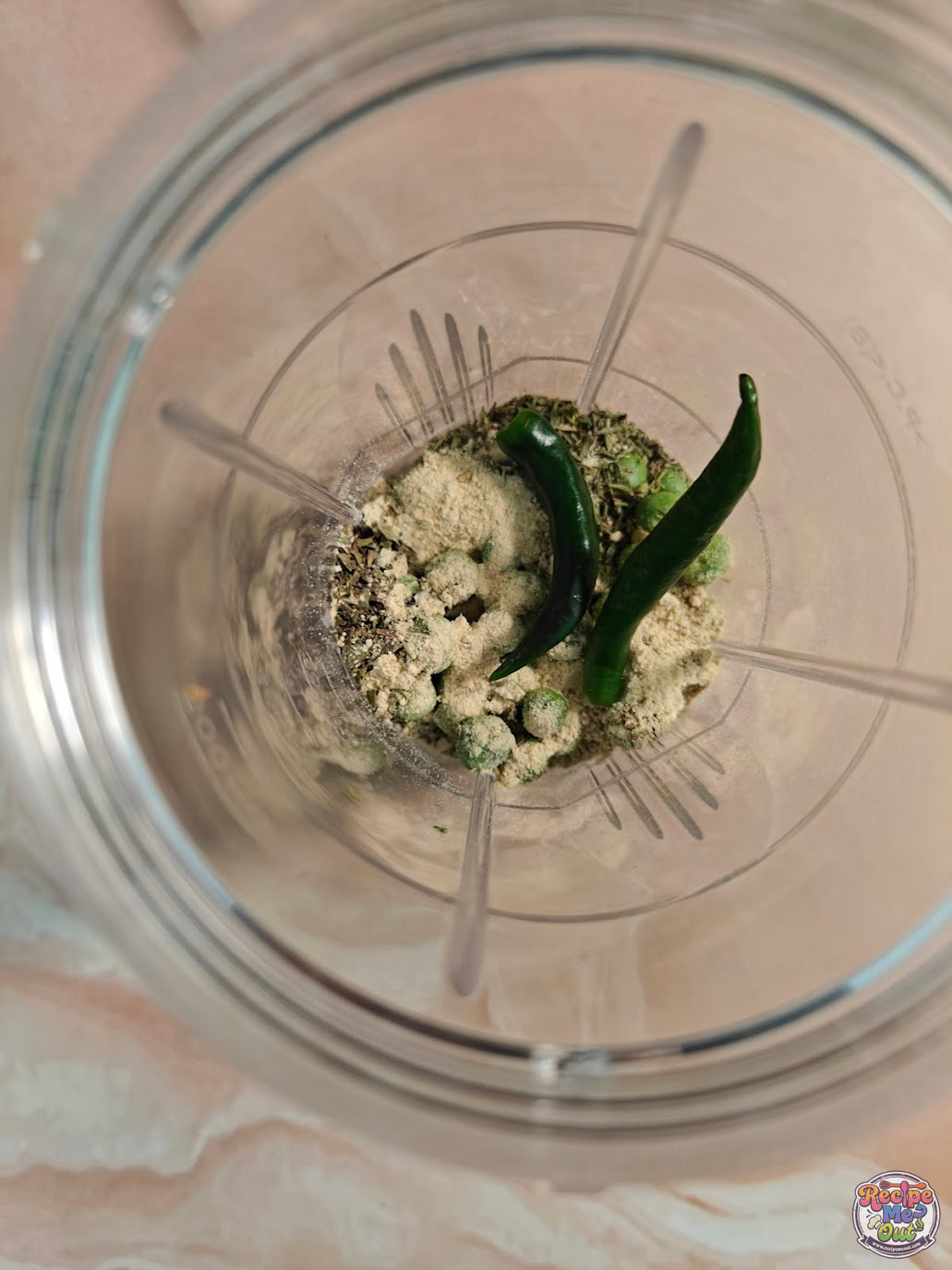 Green chillies and garlic powder added to blender mixture for Green Peas Pasta sauce