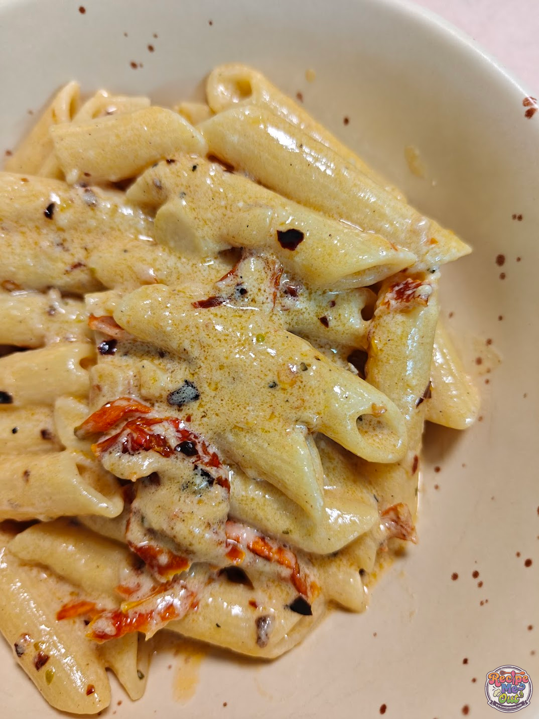 Creamy Marry Me pasta served in a bowl with sun-dried tomatoes and chilli flakes