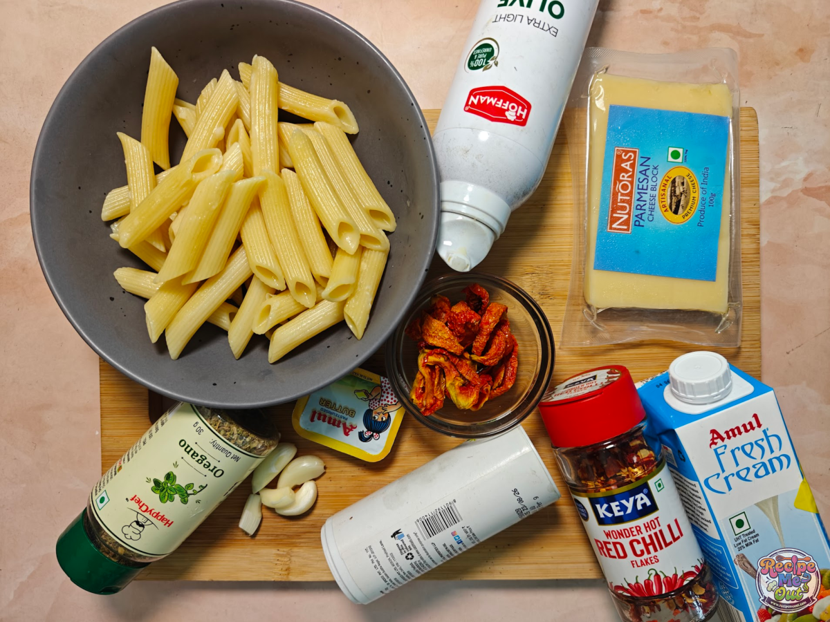 Ingredients for Marry Me pasta including pasta, cream, cheese, garlic, and sun-dried tomatoes