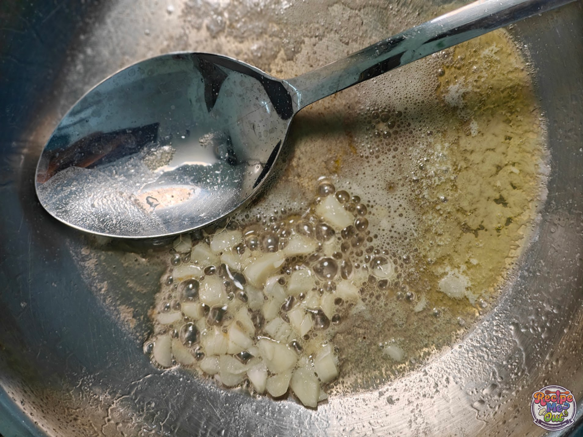 Chopped garlic sautéing in melted butter until fragrant