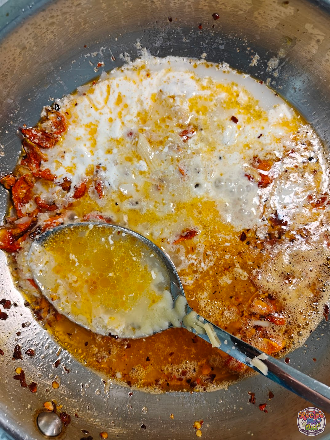 Creamy sauce mixed smoothly simmering in the pan