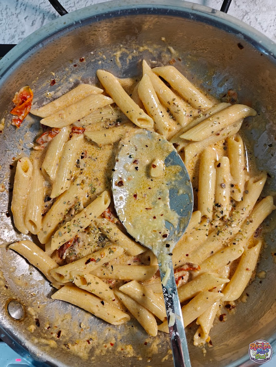 Pasta tossed in creamy sauce with oregano