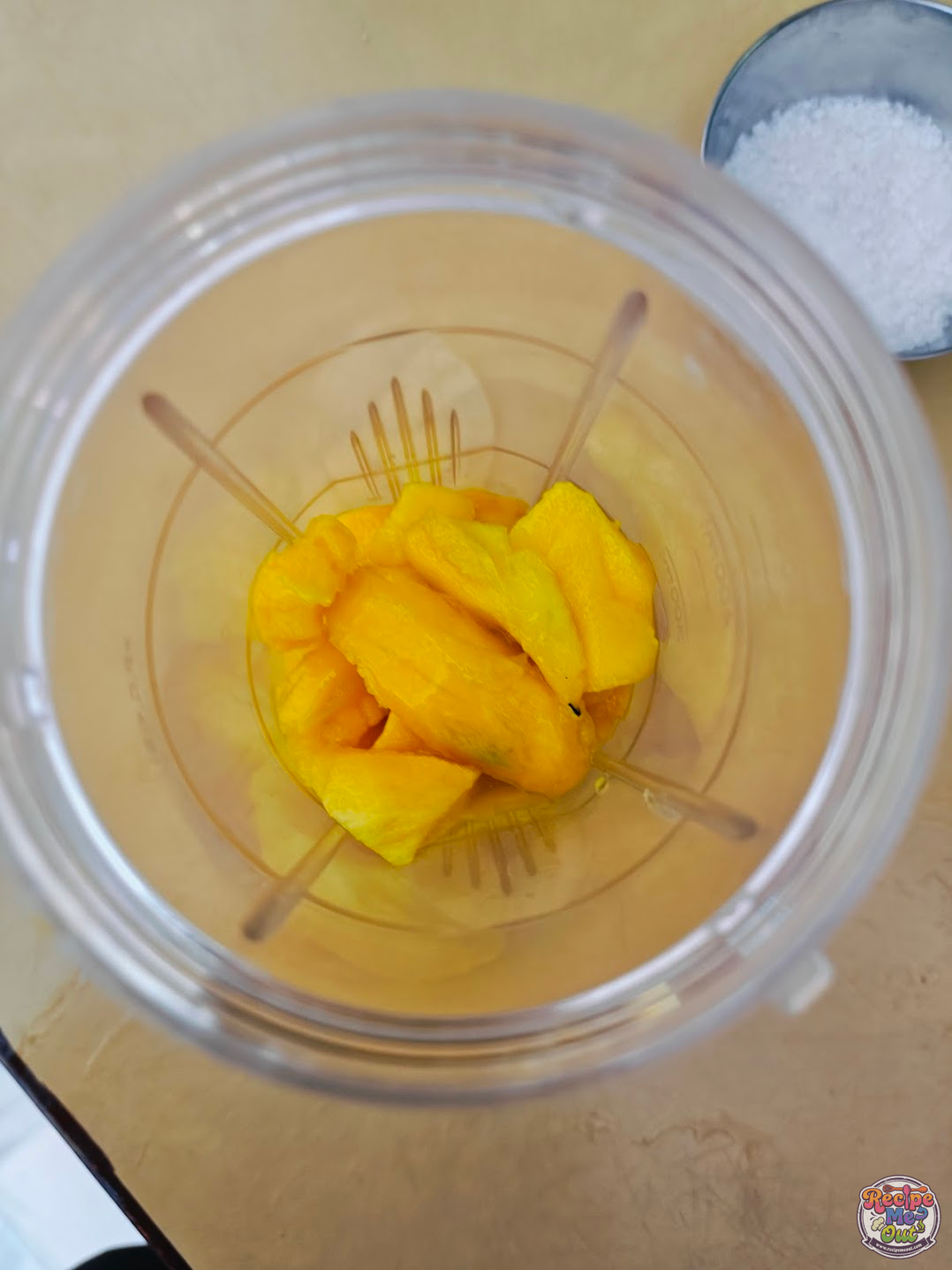 mango chunks added to a blender