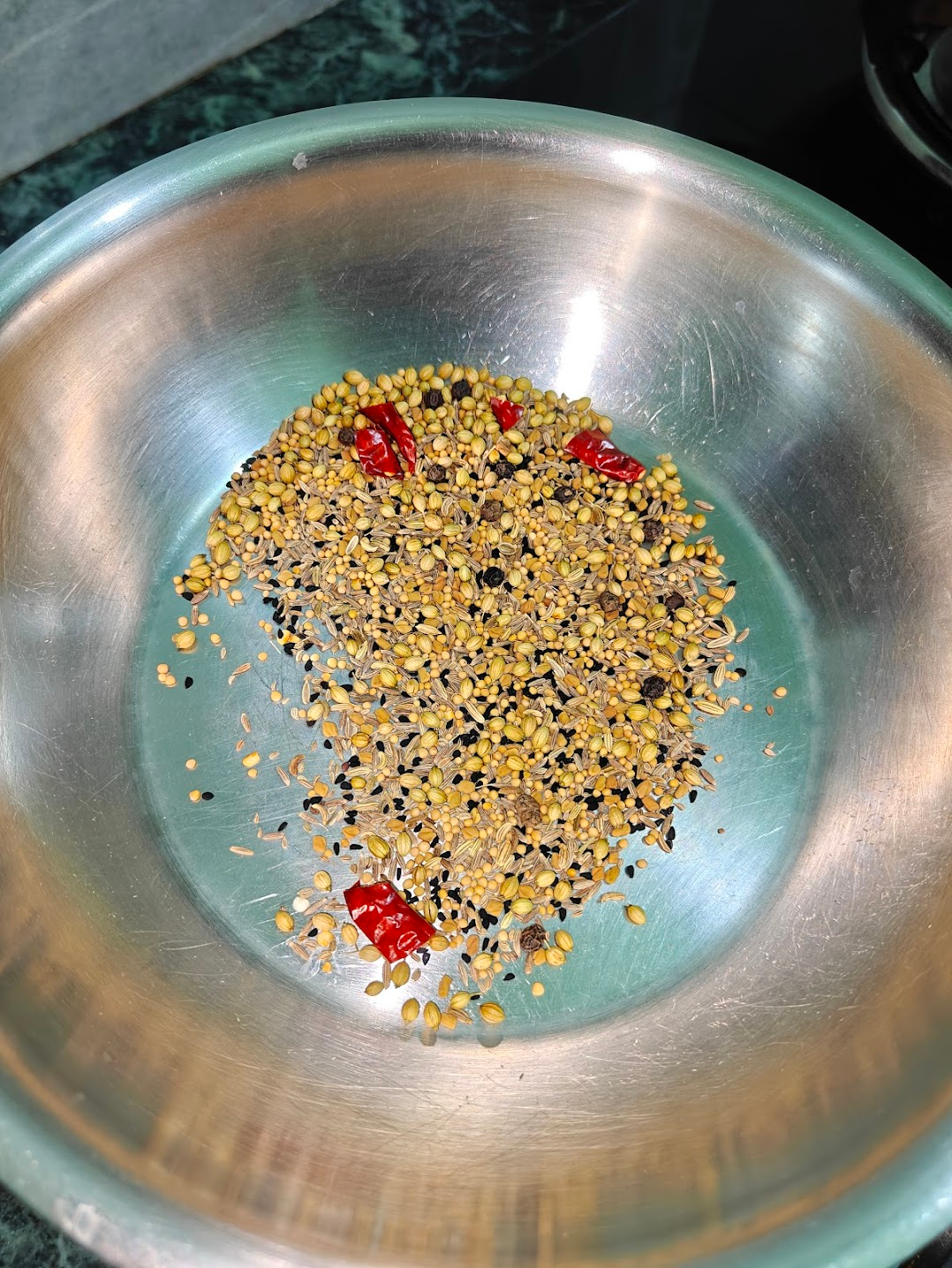 whole spices being dry roasted to make the spice mix for the achari aloo (pickled potatoes)