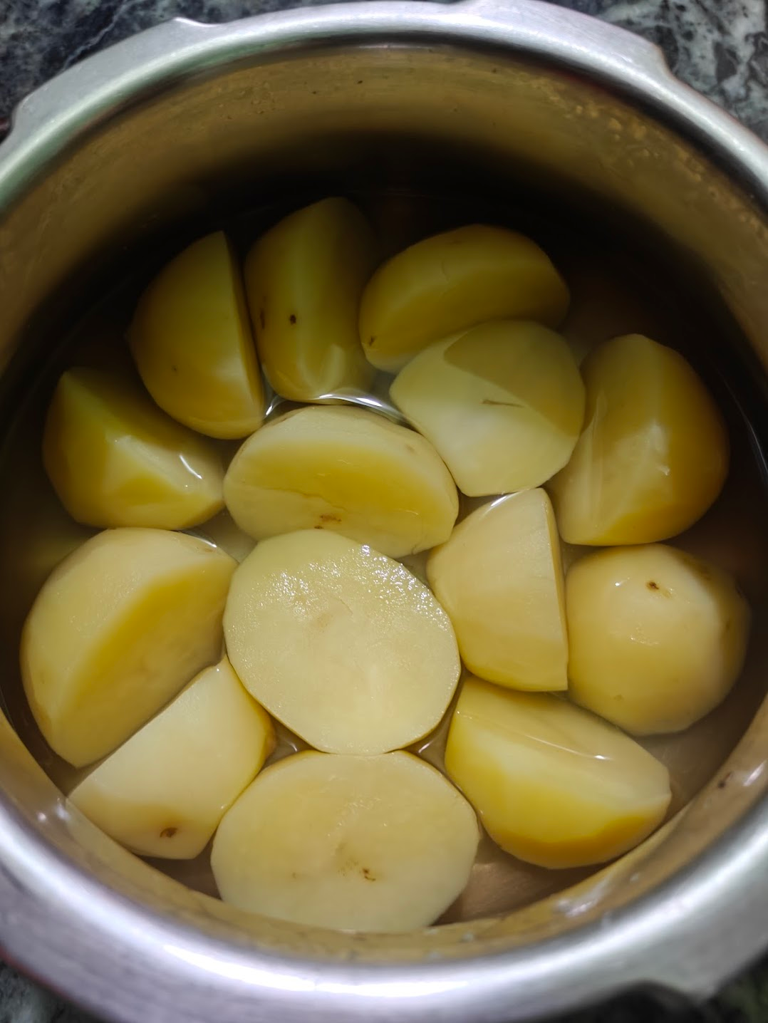 boiled potatoes inside a pressure cooker