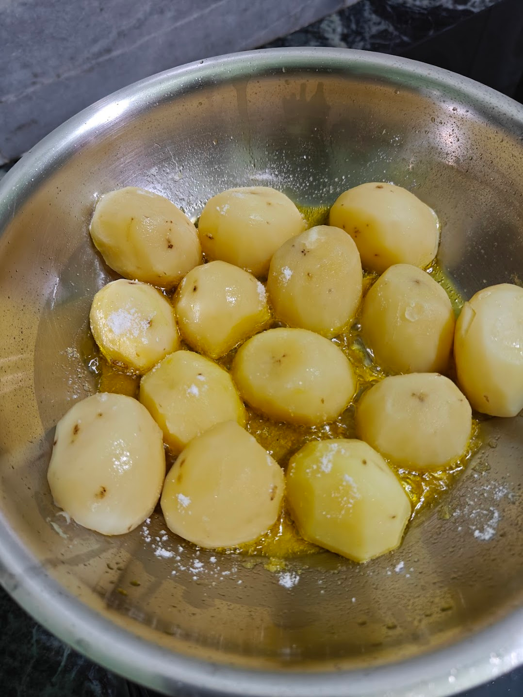 Boiled potatoes frying in hot oil