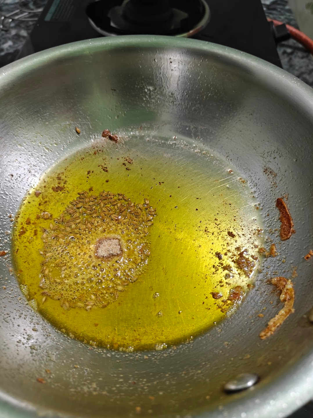 fennel seeds and Asafoetida added to the pan over the heated oil