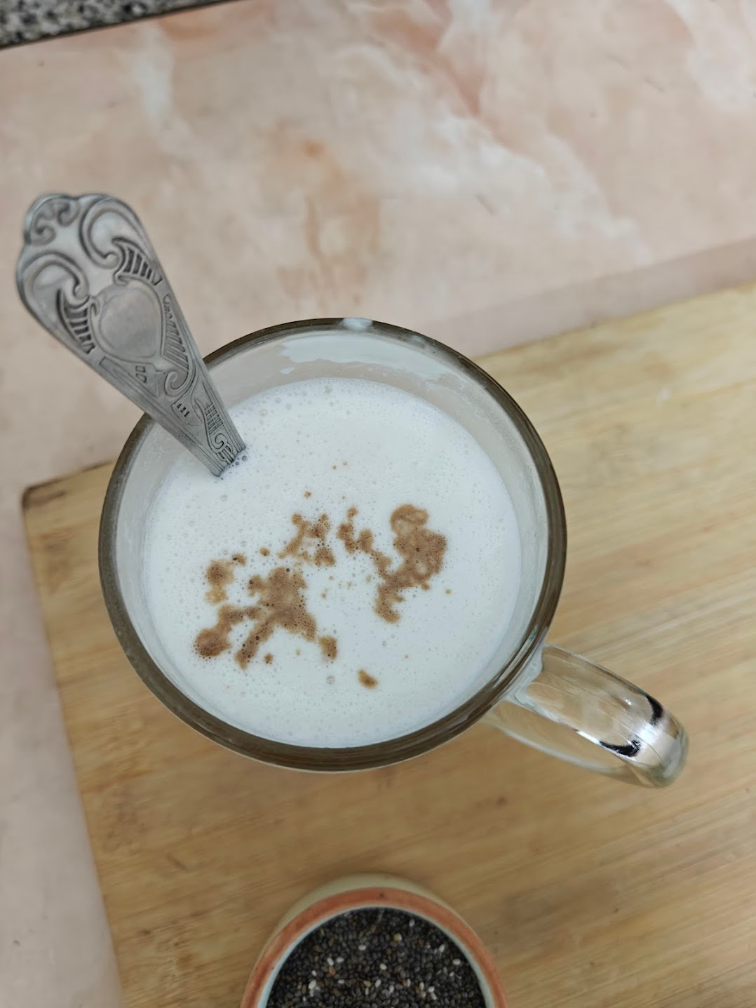vanilla essence being added to the coconut milk and honey mixture