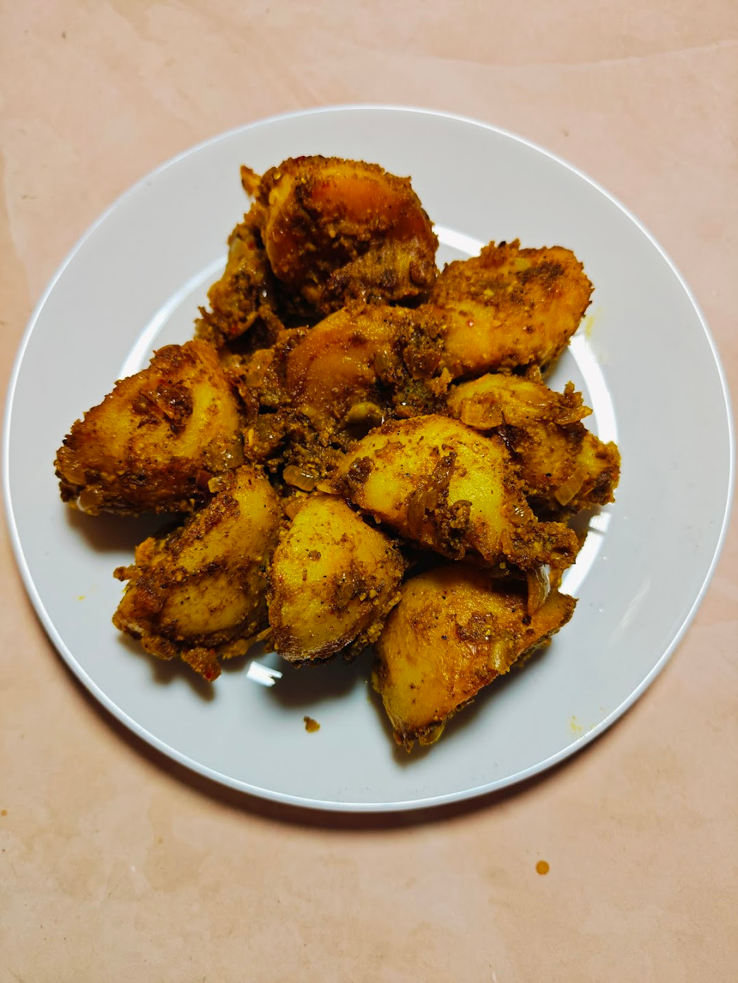 Closeup Shot of Achari Aloo (Pickled Potatoes) on a White Plate