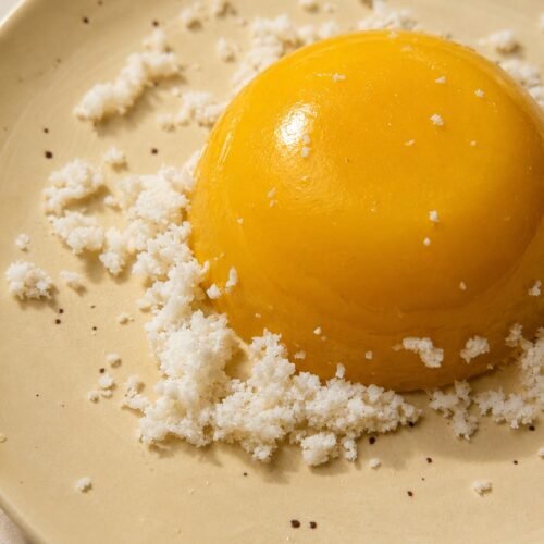 Mango Coconut Pudding with desiccated coconut lying on a plate