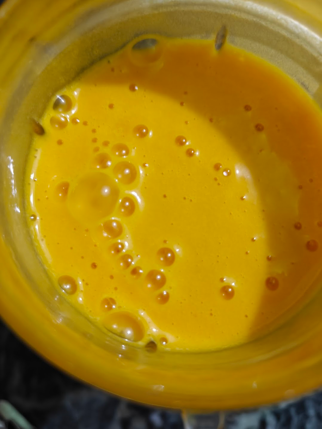 Smooth mango pudding mixture inside a blender jar