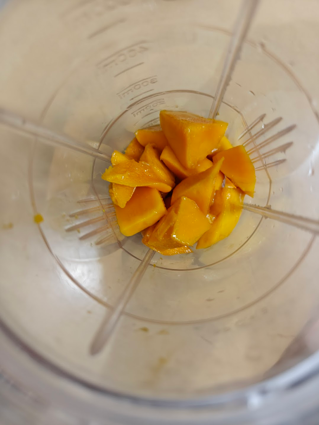 Ripe mango pieces in a blender jar for coconut mango pudding